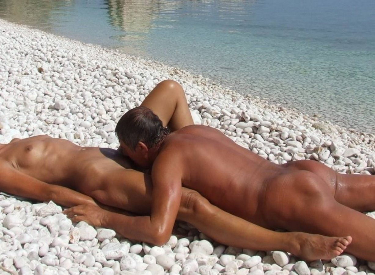 Liking nudist pussy on beach